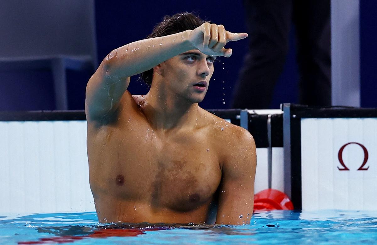 Italy's Thomas Ceccon waves to the crowd after winning the men's 100m Backstroke final.