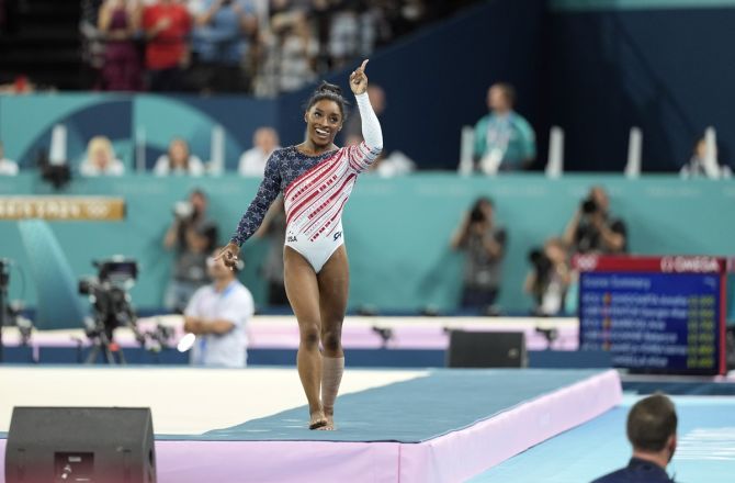 Simone Biles reacts with the number one sign after the women’s team final.