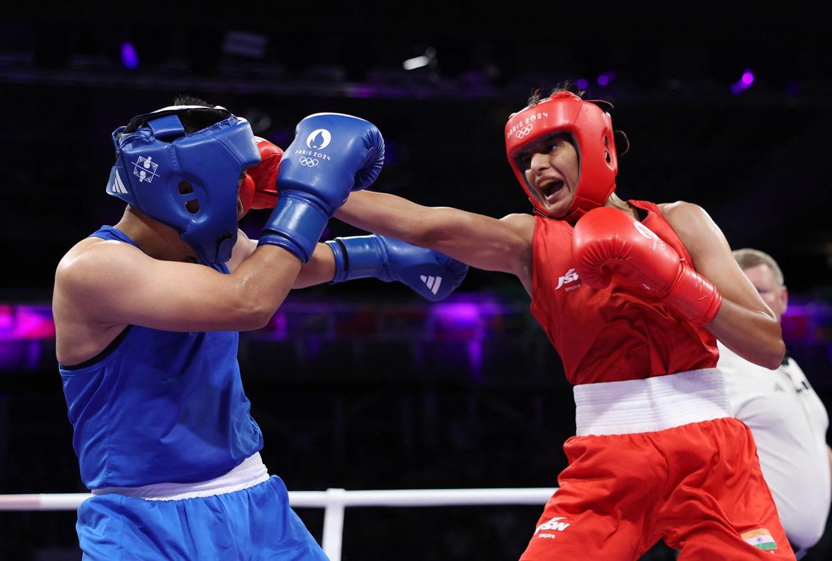 India's Jaismine Lamboria lands a punch on Nesthy Petecio's head during the women's 57kg Round of 32 bout.