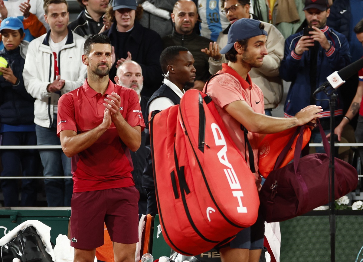 Novak Djokovic applauds Lorenzo Musetti after the marathon match.