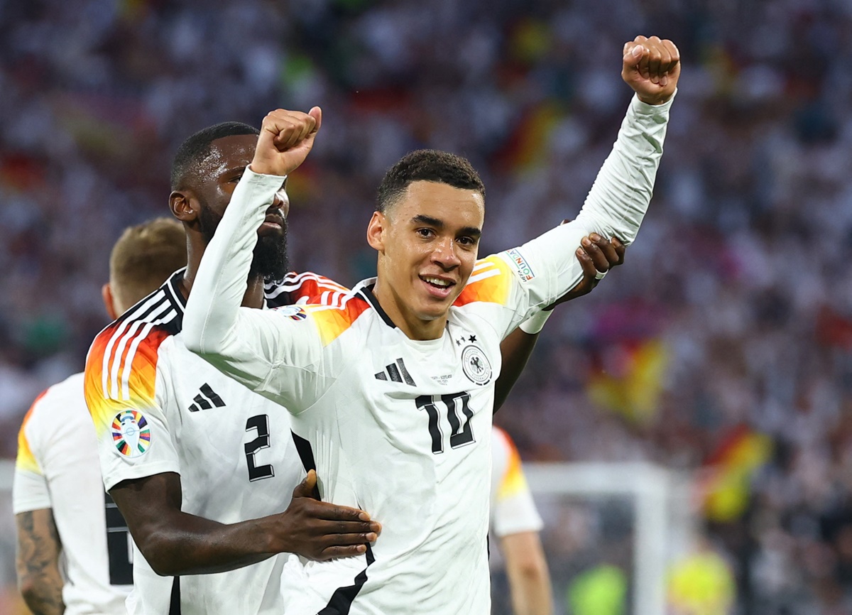 Jamal Musiala celebrates with Antonio Rudiger after scoring Germany's second goal.