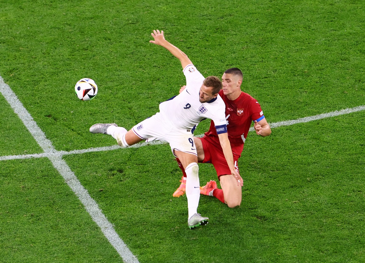 England striker Harry Kane is tackled by Serbia's Nikola Milenkovic.