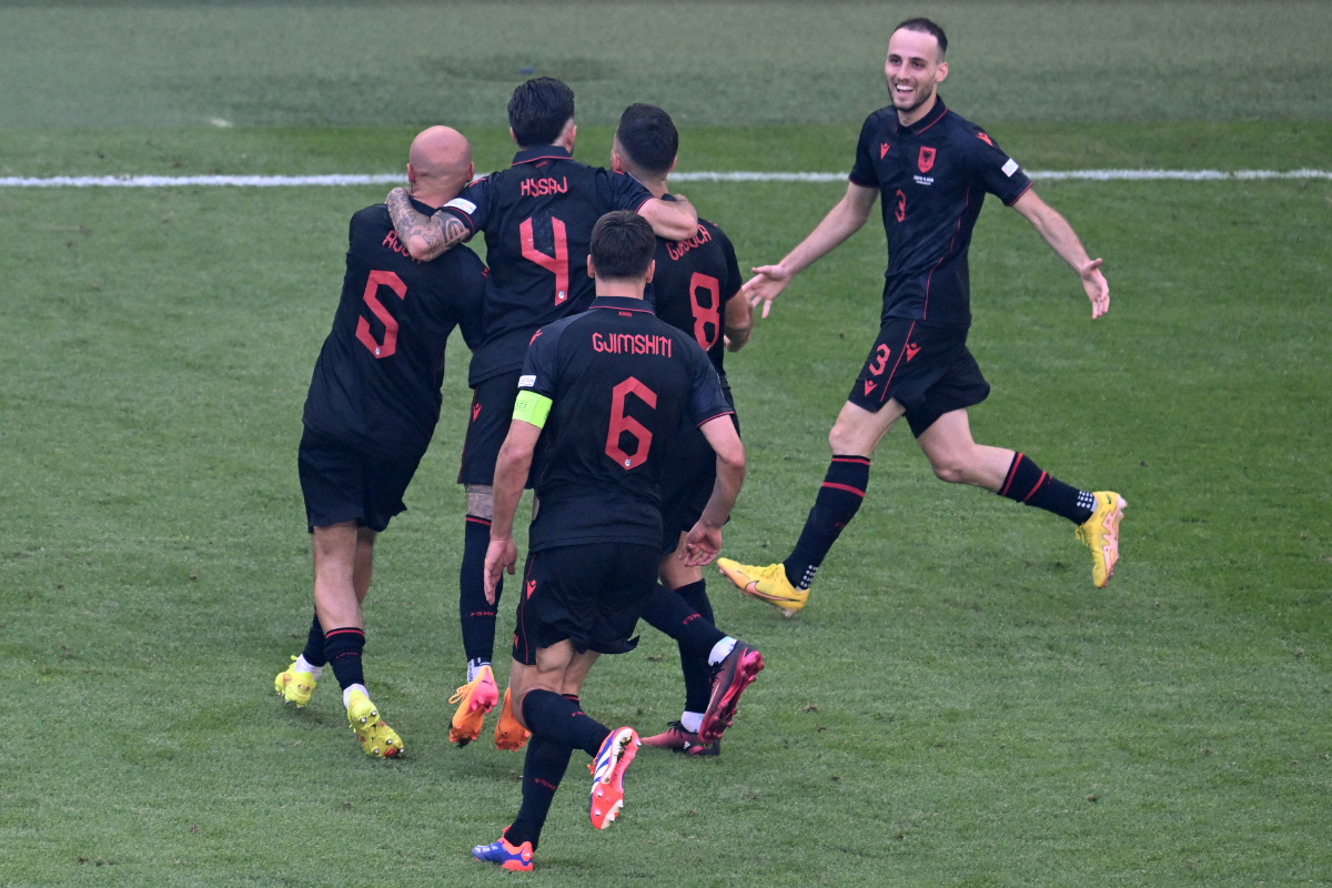 Albania's Klaus Gjasula celebrates with teammates on scoring the match-saving equaliser.