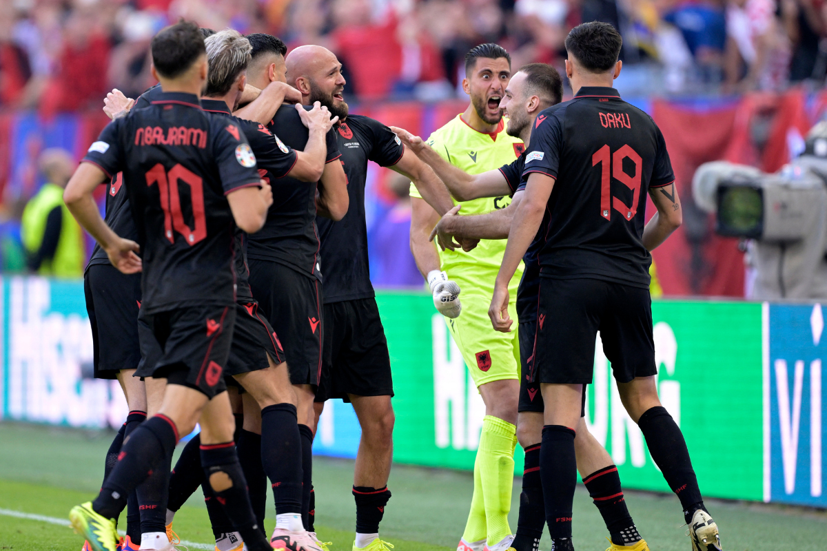 Albania's Klaus Gjasula celebrates scoring their equaliser