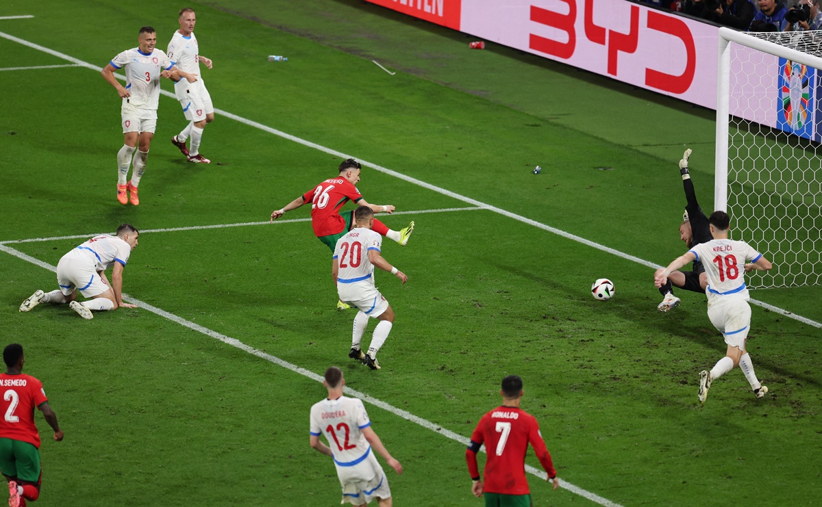 Substitute Francisco Conceicao (No. 26) sends the ball past Czech Republic goalkeeper Jindrich Stanek in the third minute of added time.
