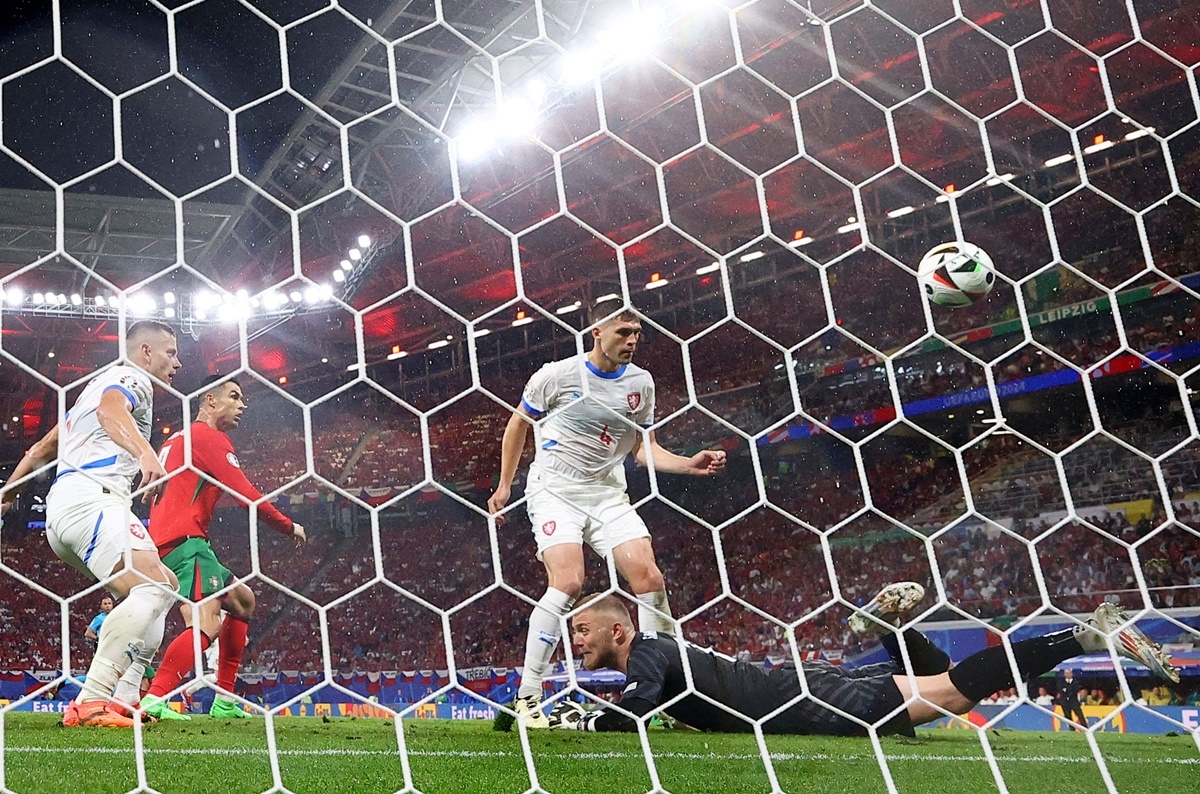 Czech Republic defender Robin Hranac (No. 4) deflects the ball after it ricochets off goalkeeper Jindrich Stanek into his own goal to enable Portugal restore parity.