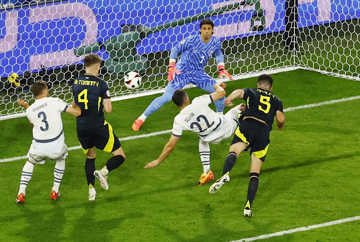 Scotland's Grant Hanley heads at goal but into the post.