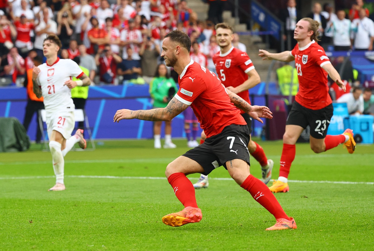 Marko Arnautovic celebrates scoring Austria's third goal from the penalty spot.