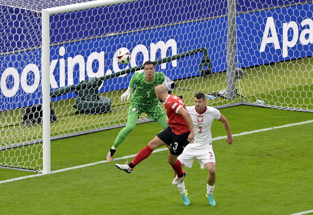 Gernot Trauner heads the ball past Poland goalkeeper Wojciech Szczesny for Austria's opening goal in the Euro 2024 Group D match at Berlin Olympiastadion, in Berlin, on Friday.
