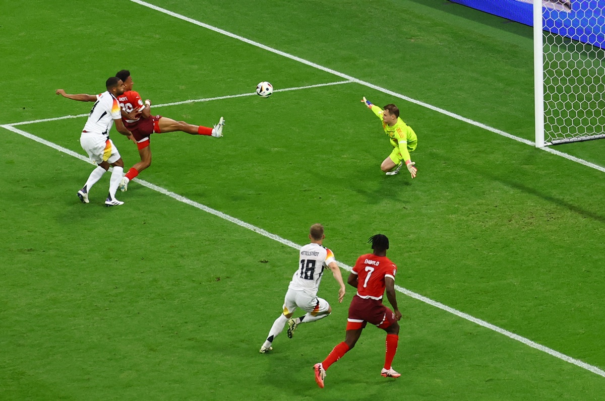 Dan Ndoye sends the ball past Germany's goalkeeper Manuel Neuer to put Switzerland ahead.