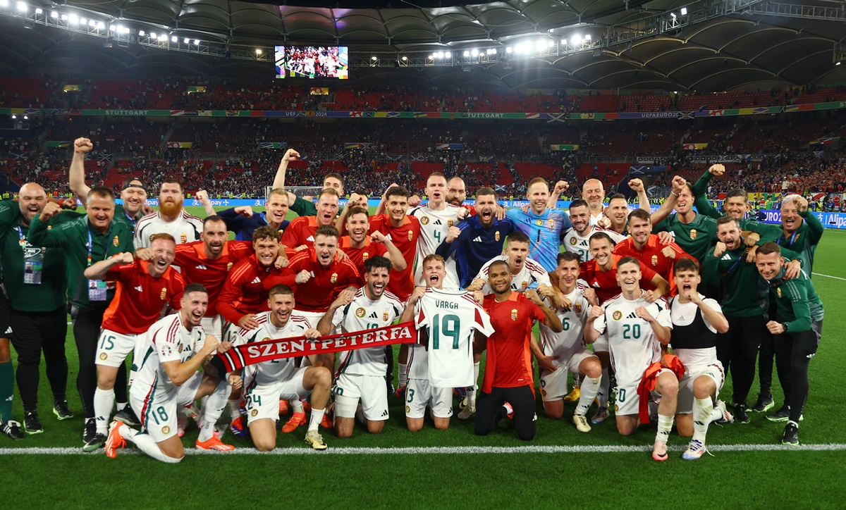 Hungary's players celebrate after the match holding up a jersey of Barnabas Varga, who was stretchered off.