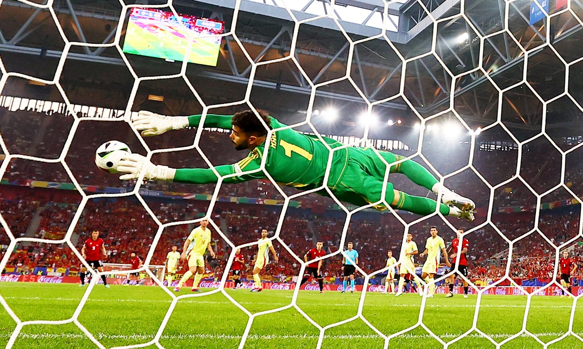 Spain's goalkeeper David Raya saves a shot from Albania's Kristjan Asllani.