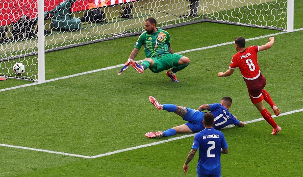 Italy's goalkeeper Gianluigi Donnarumma watches as Remo Freuler sends the ball to the far corner of the net for Switzerland's first goal in the Euro 2024 Round of 16 match at Berlin Olympiastadion, Berlin, Germany, on Saturday.