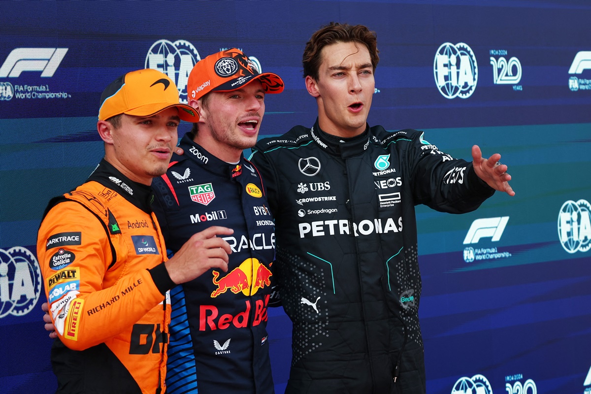 Max Verstappen celebrates after qualifying in pole position with second placed McLaren's Lando Norris and third-placed Mercedes's George Russell.