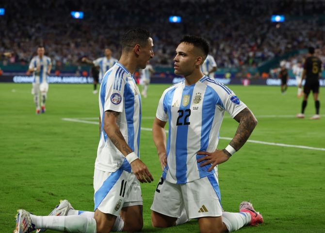 Lautaro Martinez celebrates scoring Argentina's first goal with Angel Di Maria.