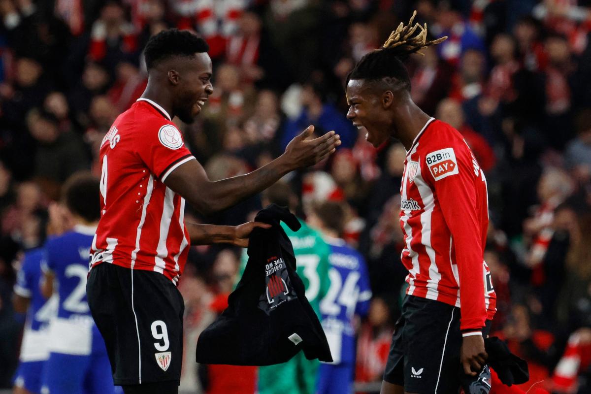 Athletic Bilbao's Inaki Williams celebrates with Nico Williams after their win over Atletico Madrid in the Copa del Rey semi-final second leg match in Bilbao, Spain, on Friday