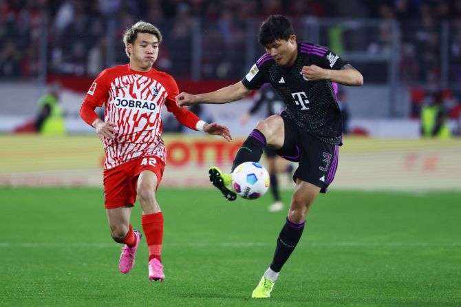 Bayern Munich's Kim Min-jae in action with SC Freiburg's Ritsu Doan during their Bundesliga match at  Europa Park Stadion, Freiburg, Germany