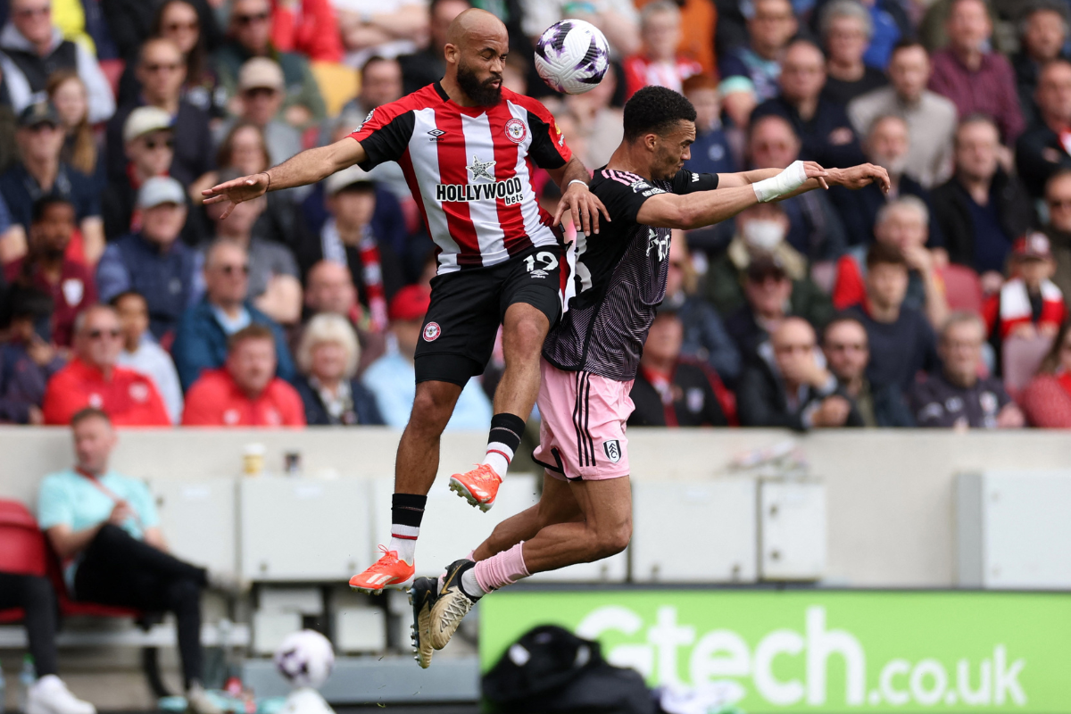 Fulham's Antonee Robinson and Brentford's Bryan Mbeumo vie for the ball in an aerial challenge 