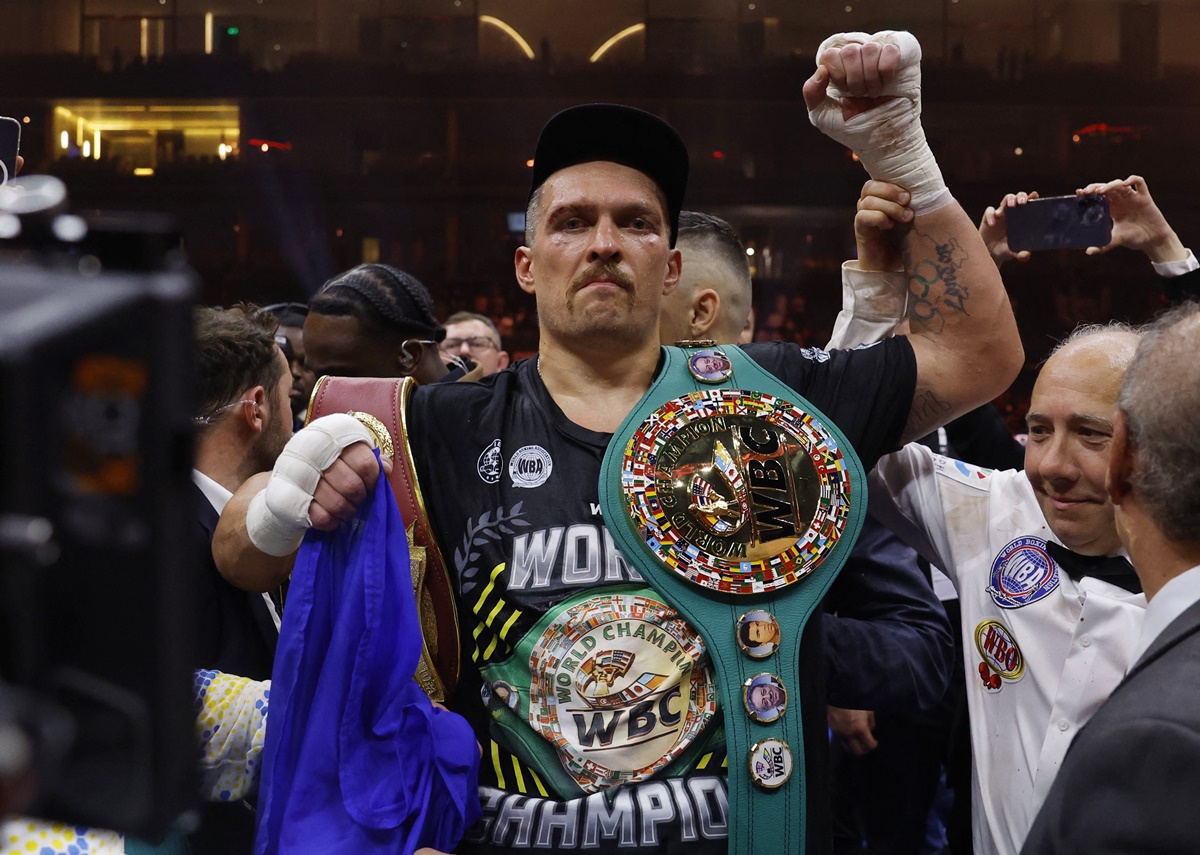 Oleksandr Usyk celebrates with the belts after beating Tyson Fury to become the undisputed heavyweight World champion at the Kingdom Arena, Riyadh, Saudi Arabia, on Saturday night.