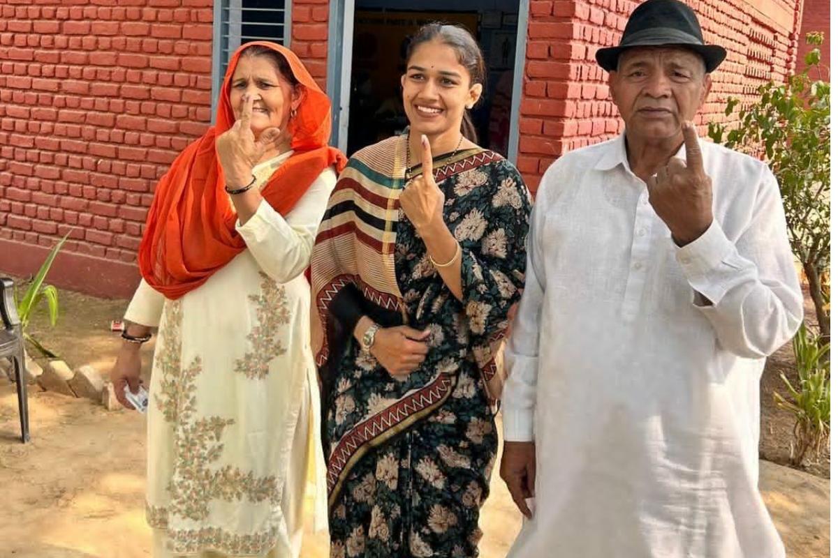 Olympian wrestler and BJP leader Babita Phogat and her parents Mahavir Singh Phogat and Daya Kaur after casting their vote during the sixth phase of the Lok Sabha Election 2024 in Haryana's Charkhi Dadri on Saturday