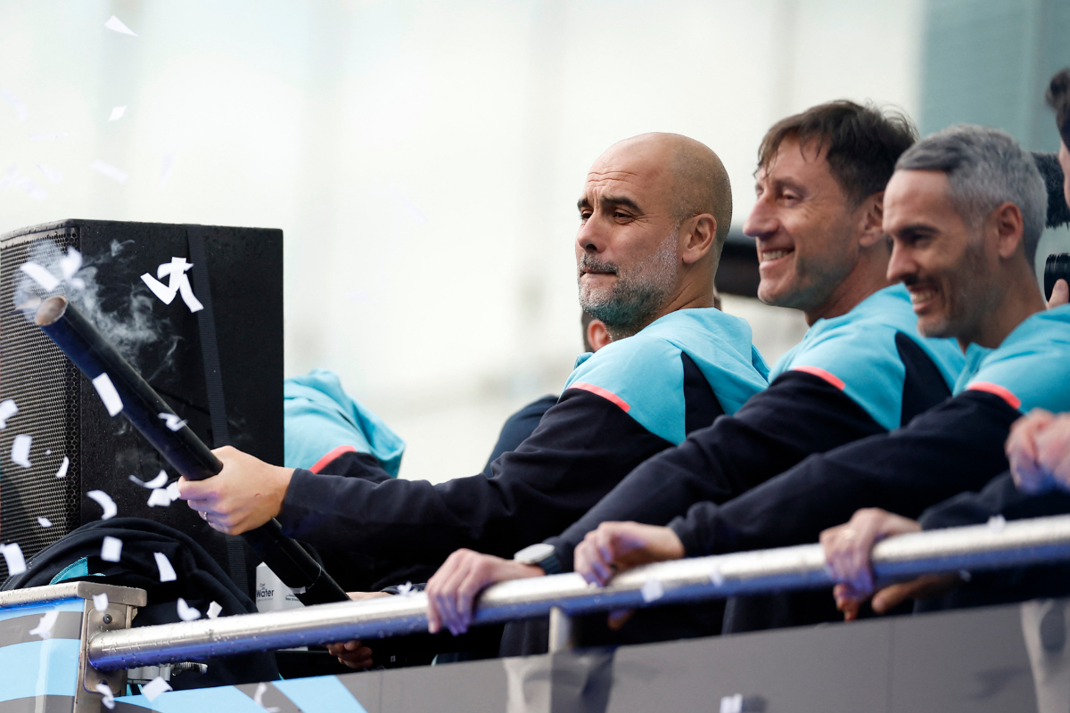 Manchester City manager Pep Guardiola on the bus during the victory parade 
