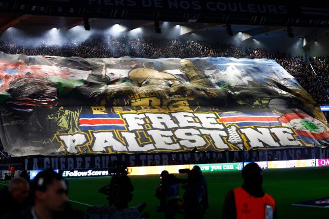 A banner on support of Palestine is displayed in the stands before the Champions League match between Paris St Germain and Atletico Madrid at Parc des Princes, Paris, France, on Wednesday