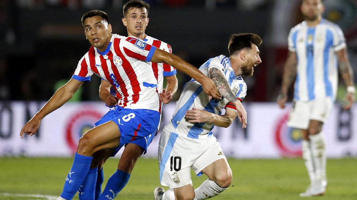 Argentina captain Lionel Messi is tackled by Paraguay's Diego Gomez