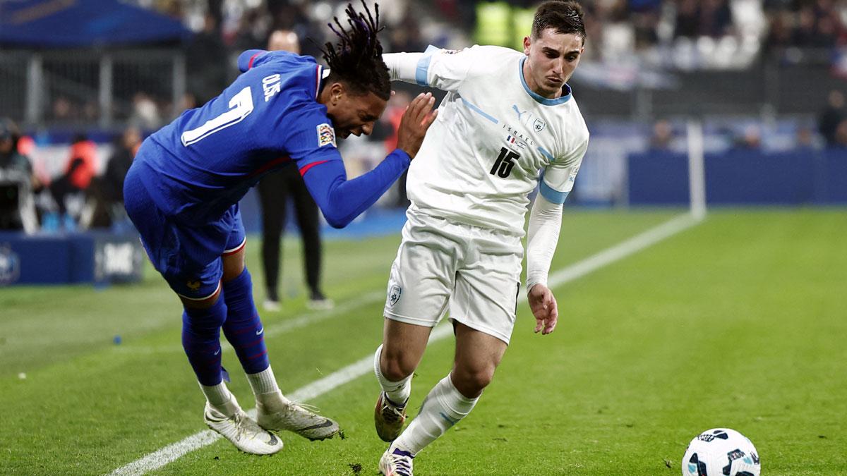 France's Michael Olise, left, is tackled by Oscar Gloukh of Israel