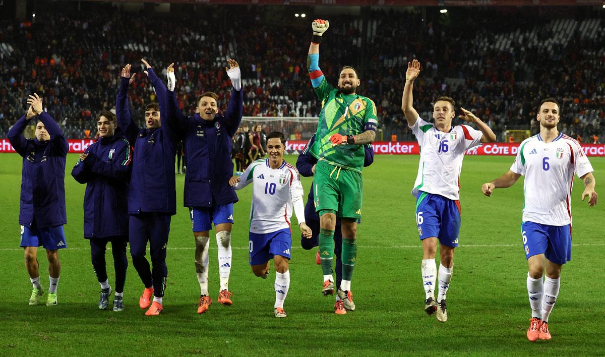 Italy's players celebrate after winning the match against Belgium 