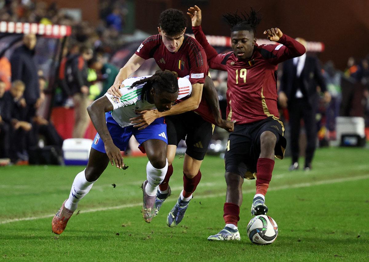 Italy's Moise Kean, left, is tackled by Belgium's Johan Bakayoko and Ameen Al Dakhil