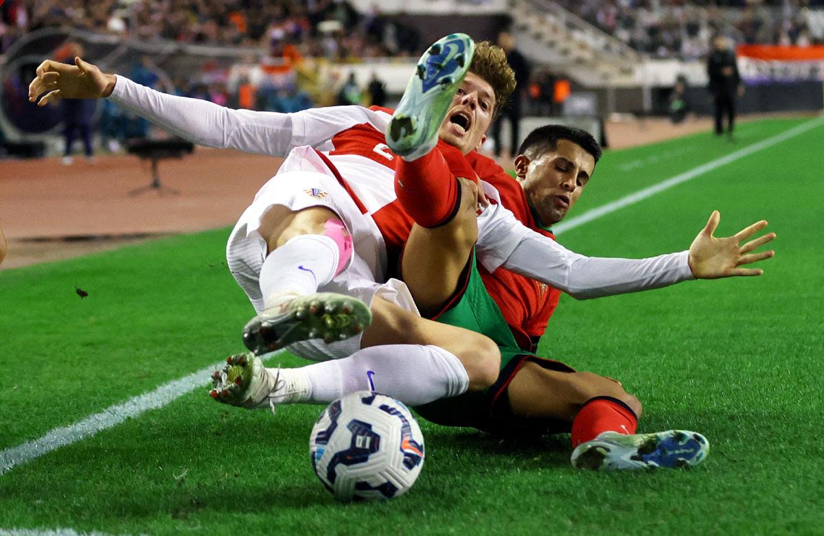 Croatia's Kristijan Jakic in action with Portugal's Joao Cancelo 