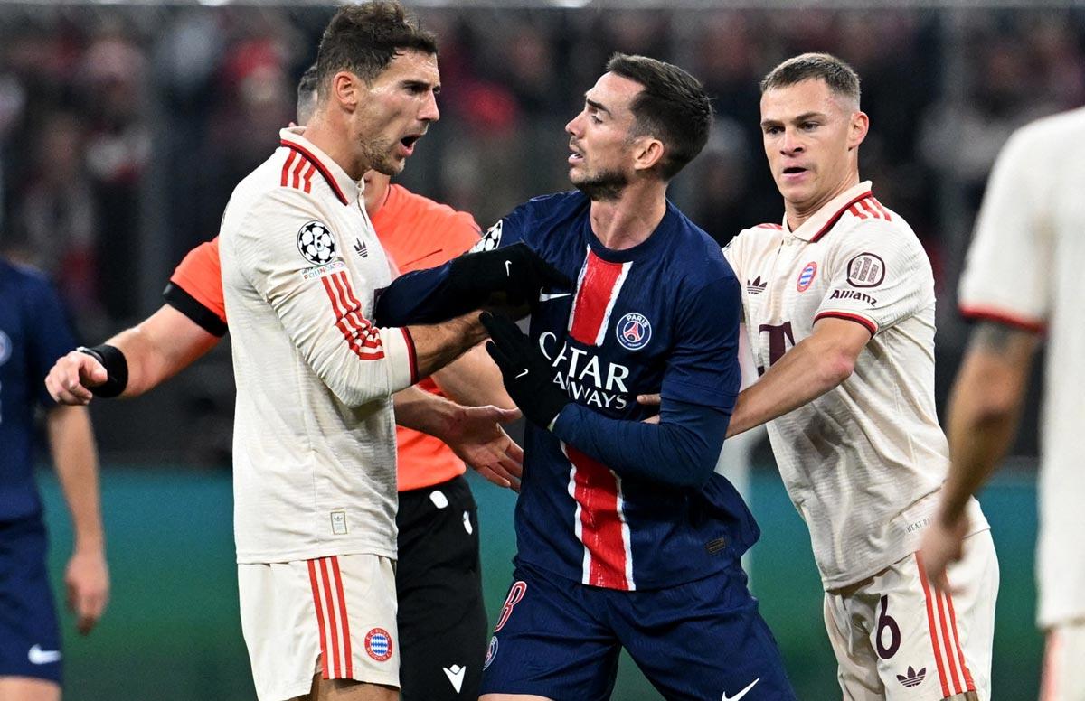 PSG's Fabian Ruiz, centre, clashes with Bayern Munich's Leon Goretzka