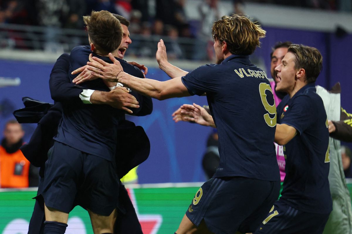 The jubilant Juventus players celebrate with coach Thiago Motta after Francisco Conceicao scored the third goal against RB Leipzig