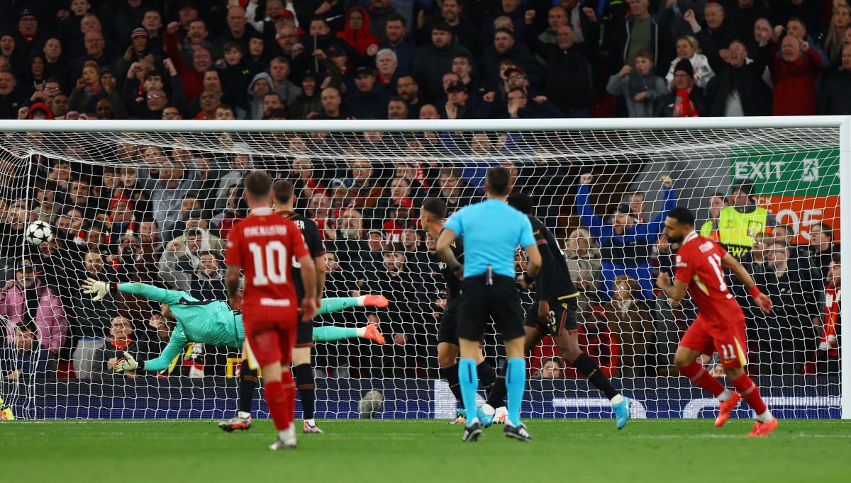 Mohamed Salah scores Liverpool's  second goal past Bologna goalkeeper Lukasz Skorupski