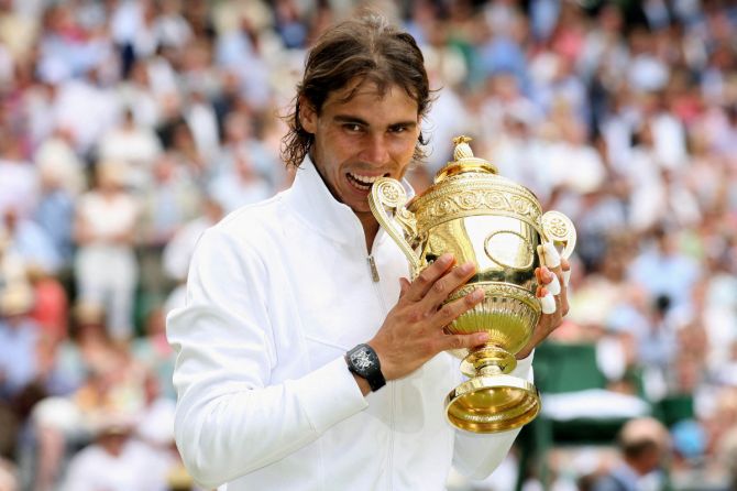 Spain's Rafael Nadal celebrates with the trophy after winning the 2010 Wimbledon title on July 4, 2010