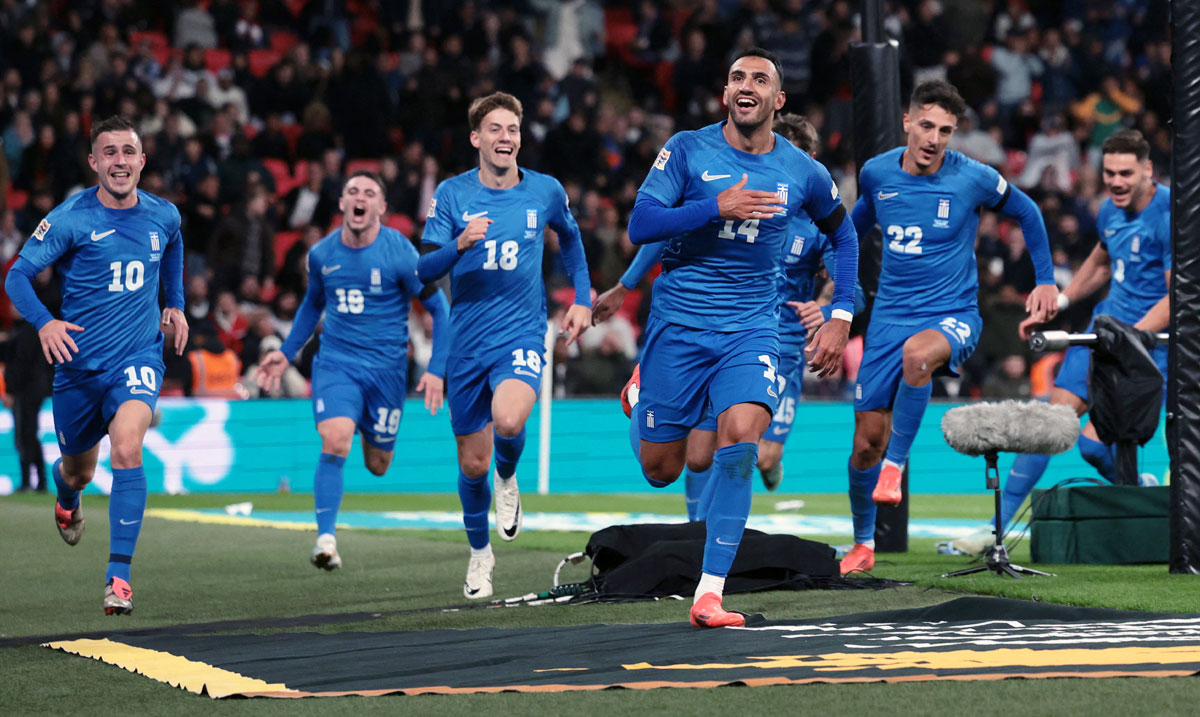 Vangelis Pavlidis celebrates with teammates after scoring Greece's second goal against England