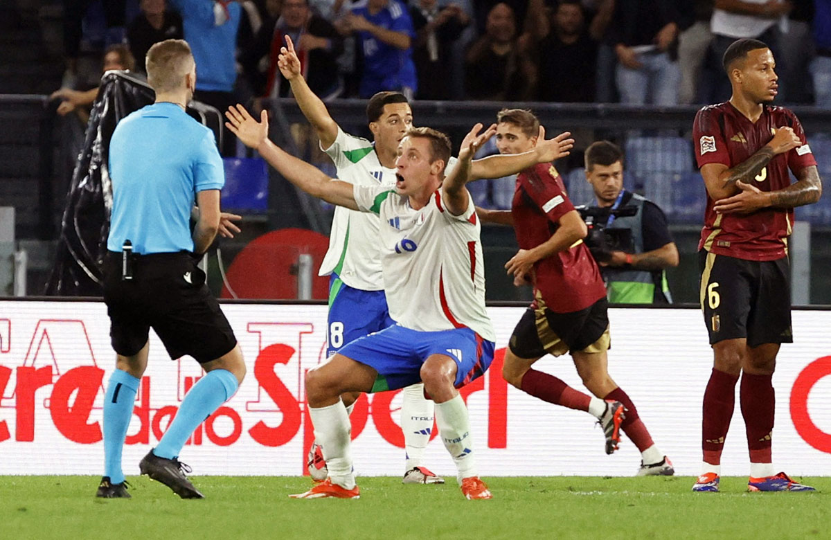 Italy's Davide Frattesi protests with referee Espen Eskas