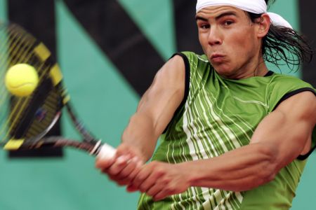 Rafael Nadal of Spain returns the ball to Lars Burgsmuller of Germany in the first round of the French Open tennis tournament at Roland Garros May 23, 2005.