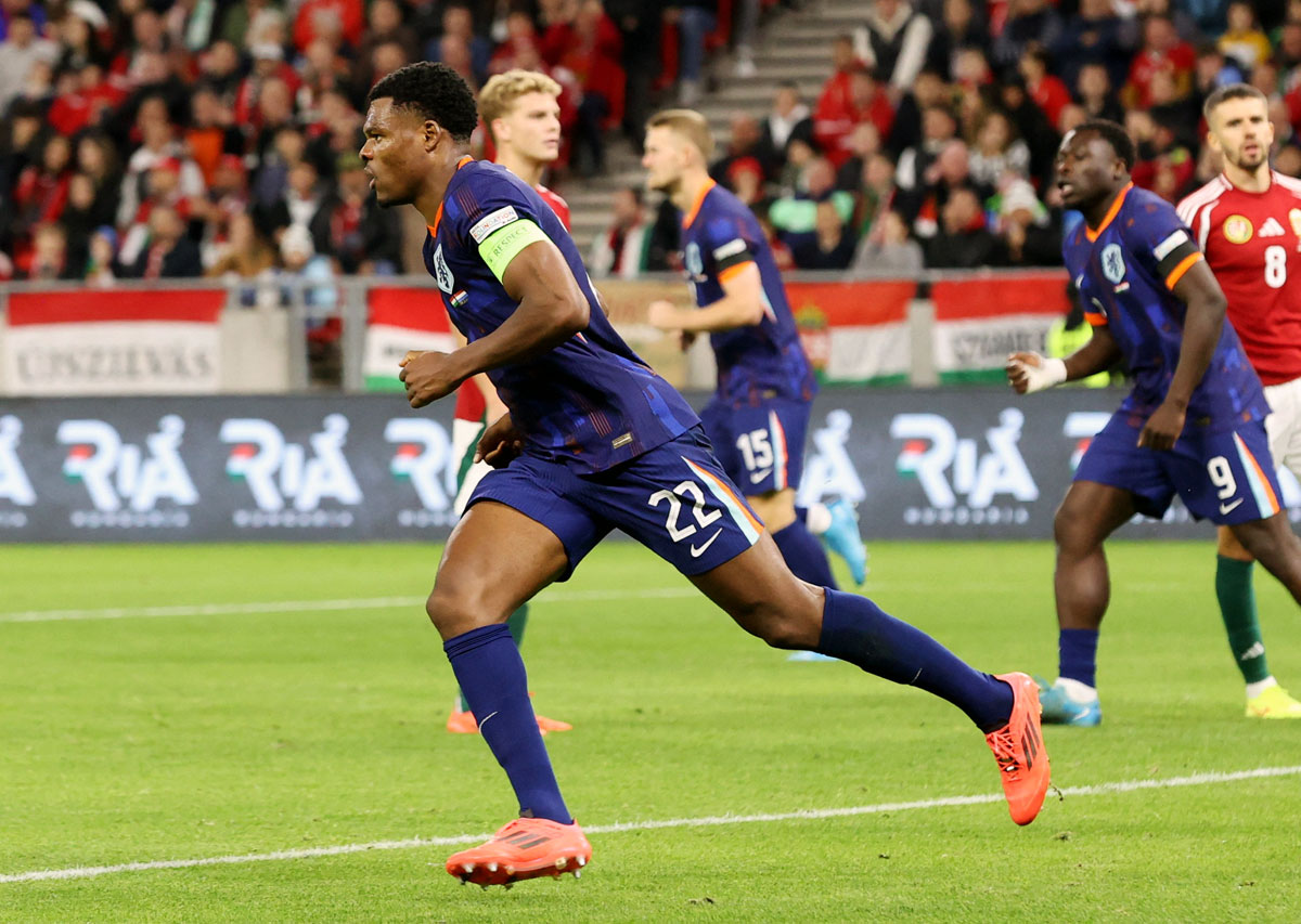 The Netherlands' Denzel Dumfries celebrates scoring the equaliser