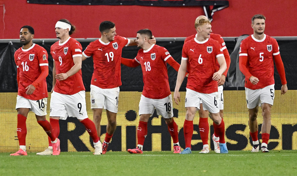 Austria's players celebrate after Philipp Lienhart scored the third goal against Norway