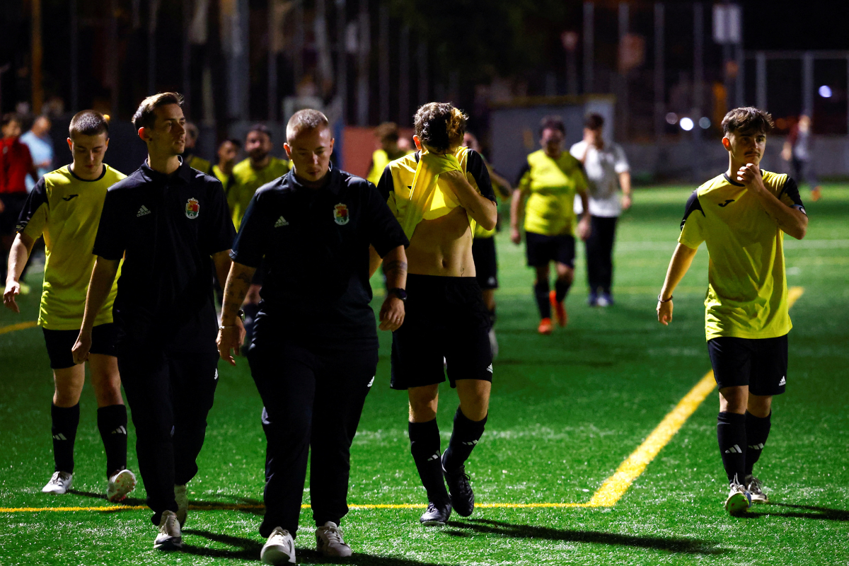 P.R. Sant Feliu Llobregat C - Fenix (Spain's first federated transgender soccer team to achieve federated status) coaches Alex Darocas and Alan and players Hugo Martinez and Luck Ibanez leave the pitch during their first official soccer match against Palleja CF B at a Catalan regional league, in Palleja city, near Barcelona, Spain September 21, 2024