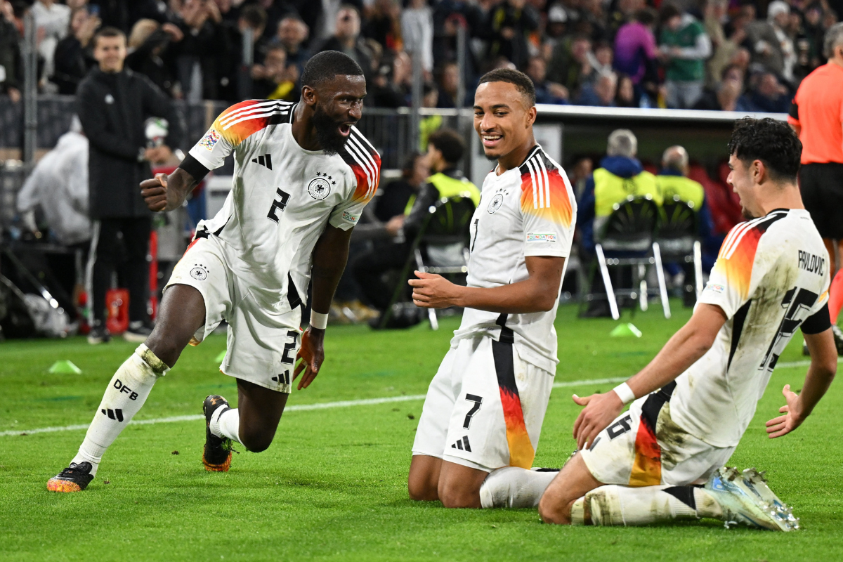 Germany's Jamie Leweling celebrates with Antonio Rudiger and Aleksandar Pavlovic after scoring against Netherlands in their UEFA Nations League Group A3 match Allianz Arena, Munich, Germany