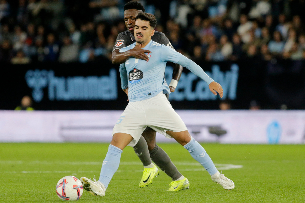 Real Madrid's Vinicius Junior in action with Celta Vigo's Damian Rodriguez