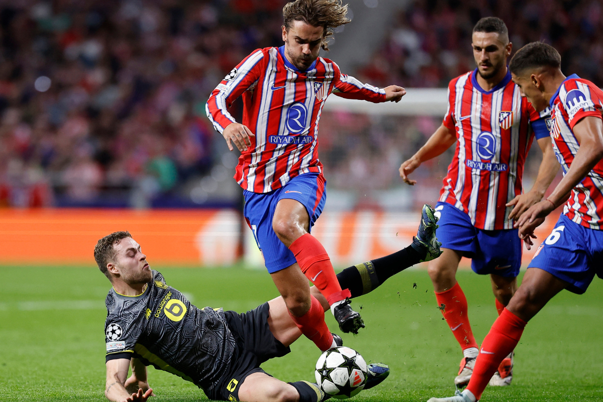 Atletico Madrid's Antoine Griezmann and Nahuel Molina in action with Lille's Gabriel Gudmundsson during their match at Civitas Metropolitano, Madrid, Spain.