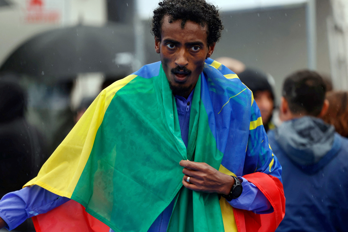 Ethiopia's Yomif Kejelcha celebrates after winning and setting a new half marathon world record with a time of 57 minutes 30 seconds at the Valencia Half Marathon, Valencia, Spain on Sunday