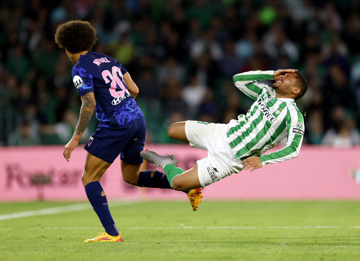 Real Betis' Vitor Roque is tackled by Axel Witsel of Atletico Madrid