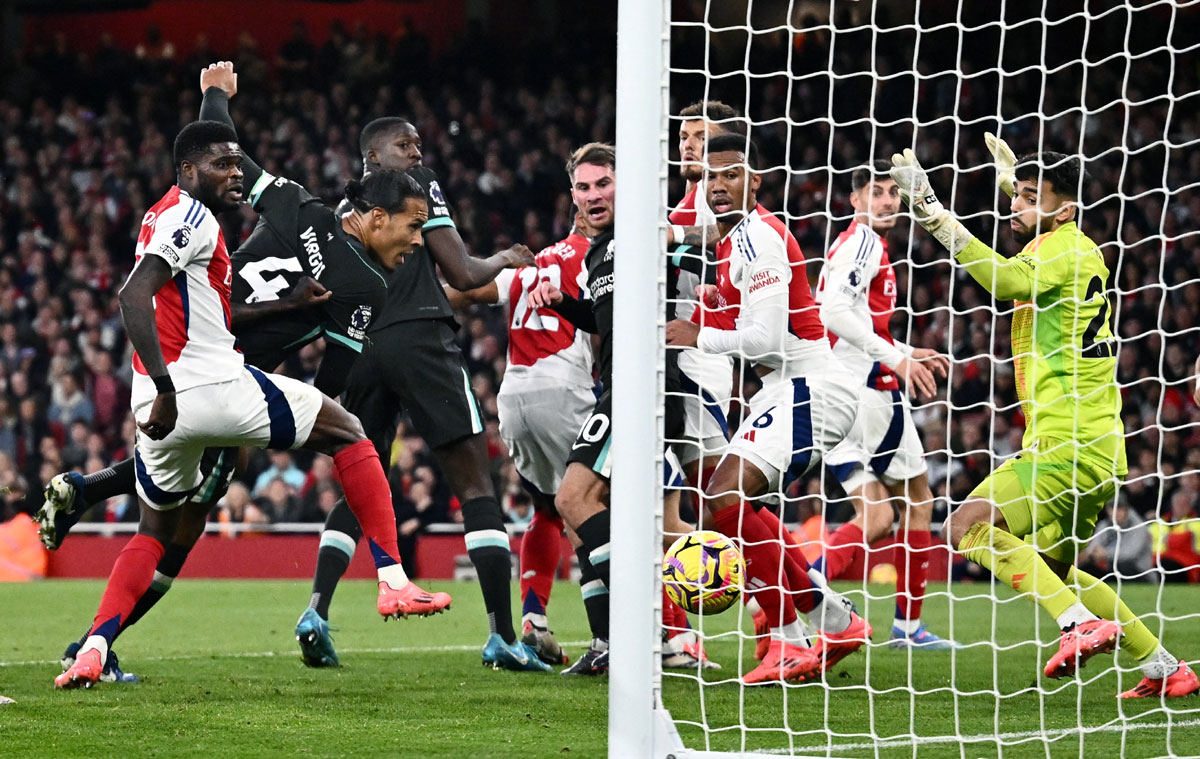 Liverpool's Virgil van Dijk scores their first goal