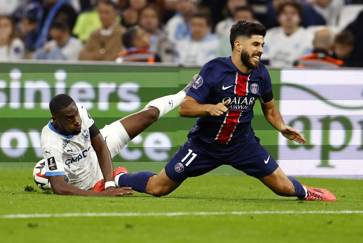 PSG's Marco Asensio is tackled by Geoffrey Kondogbia