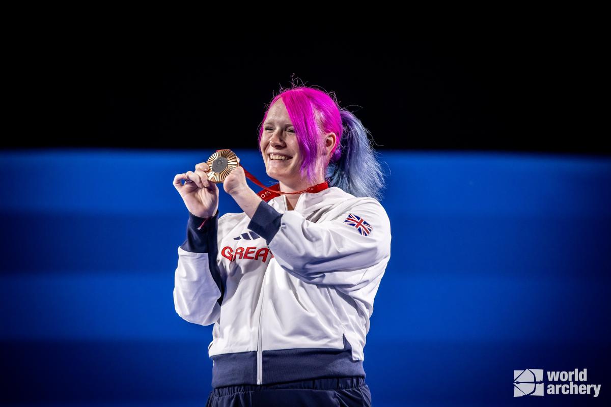 British archer Jodie Grinham celebrates on the podium after wining bronze in the compound archery event at the Paris Paralympics on Sunday