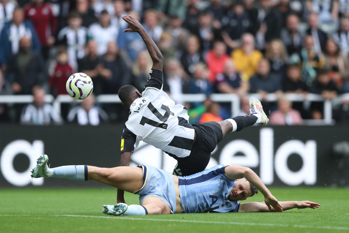 Tottenham Hotspur's Radu Dragusin and Newcastle United's Alexander Isak collide during a challenge